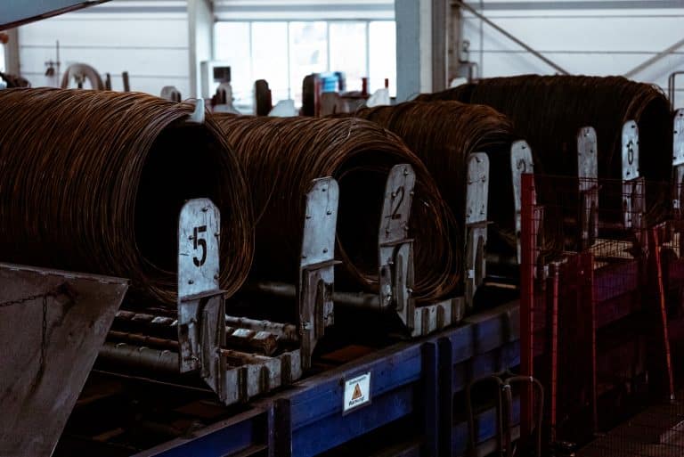 Viele Drahtcoils liegen gut gelagert auf einem Aufgabetisch in einem Stahlbetrieb